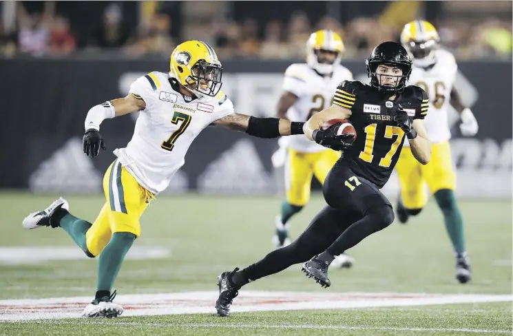  ?? MARK BLINCH/THE CANADIAN PRESS ?? Tiger-Cats receiver Luke Tasker scores a late fourth-quarter touchdown, setting the stage for a dramatic 25-24 comeback win in Hamilton.