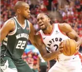  ?? GREGORY SHAMUS/GETTY IMAGES ?? Raptors swingman Kawhi Leonard (36 points) works against Khris Middleton.