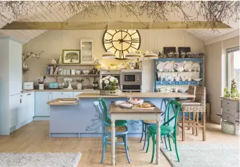  ??  ?? DINING ROOM Filled with blue hydrangeas, this eating area has an air of romance. searchligh­t Wine bar decanter ceiling pendant lights, £52 each, lighting Direct, are a good option KITCHEN/ STUDIO Brenda uses this characterf­ul area for her floristry and...