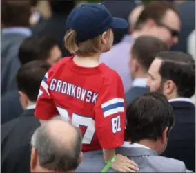  ?? ANDREW HARNIK — THE ASSOCIATED PRESS ?? A youth wears a jersey of New England Patriots tight end Rob Gronkowski during Wednesday’s ceremony.