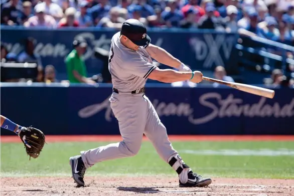 ?? AP) (Photo by Chris Young, The Canadian Press, ?? New York Yankees designated hitter Matt Holliday hits a solo home run off Toronto Blue Jays relief pitcher Jason Grilli on Saturday.