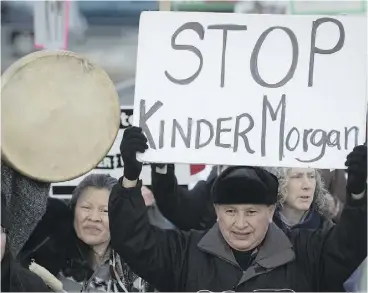  ?? DARRYL DYCK / THE CANADIAN PRESS ?? Grand Chief Stewart Phillip, president of the Union of B.C. Indian Chiefs, pickets while marching at a protest outside the National Energy Board hearings Tuesday.