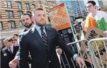  ?? NEW YORK DAILY NEWS FILE PHOTO ?? Conor McGregor, centre, arrives at Brooklyn Supreme Court in New York on June 14 in connection with his alleged April attack on a bus at Barclays Center. McGregor pled guilty to his role in the fight Thursday.