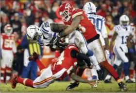  ?? CHARLIE RIEDEL — THE ASSOCIATED PRESS ?? Kansas City Chiefs linebacker Anthony Hitchens, top, and safety Jordan Lucas (24) tackle Indianapol­is Colts running back Marlon Mack (25) during the second half of an NFL divisional football playoff game in Kansas City, Mo., Saturday.