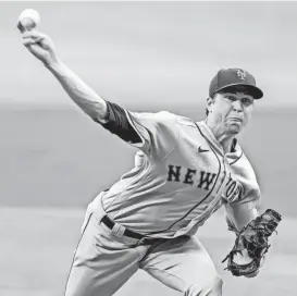  ?? DALE ZANINE/USA TODAY SPORTS ?? Mets starting pitcher Jacob deGrom pitches against the Braves at Truist Park.
