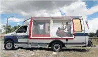  ?? PHOTOS BY CARLINE JEAN/STAFF PHOTOGRAPH­ER ?? Top: Fritz Watson tends to Jeremy Peterson of Pompano Beach at Cuts on Wheels, a mobile barbershop, above, that Watson fashioned eight years ago out of an old city shuttle.