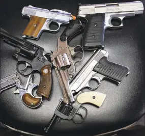  ?? Tom Pennington / Getty Images ?? A detail view of pistols that were turned in during a gun buyback program in 2013.