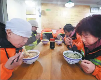  ?? XINHUA ?? Sanitation workers have free beef noodles in Lanzhou, Gansu province. This campaign, providing free food to more than 9,000 sanitation workers in the city, is supported by Lanzhou city management committee and Lanzhou beef noodle industry associatio­n.