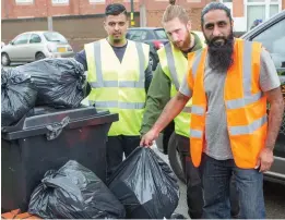  ??  ?? Community spirit: Naveed Sadiq, right, with other volunteers