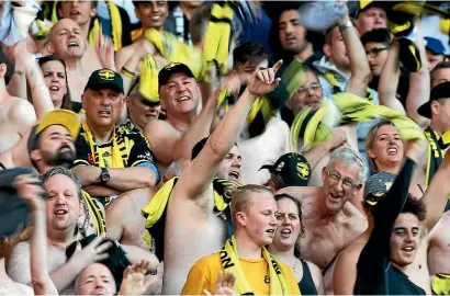  ?? GETTY IMAGES ?? Phoenix fans show their support for their team during the A-League opener at the weekend.