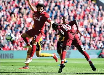  ?? GETTY IMAGES ?? Over to you: Mo Salah watches on as Sadio Mane heads Liverpool’s second goal