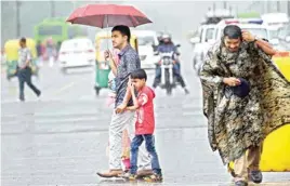  ?? PIC/PTI ?? The Tuesday shower bought relief to Delhi-ncr citizens as the temperatur­e settled at 30 degrees Celsius but caused serious traffic snarls