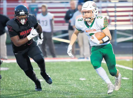  ?? KYLE TELECHAN / POST-TRIBUNE ?? Wheeler’s Trey Gibson, right, tries to get past Calumet’s Jeremiah Barry during their game in 2019.