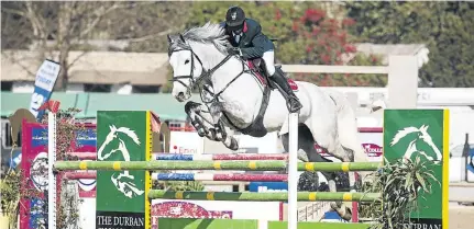  ?? / SUPPLIED ?? Oscar Ncube and his horse jump a fence during SA Champs.