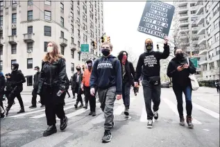  ?? Spencer Platt / Getty Images ?? People march through the streets of Manhattan on Monday to protest the recent killing of a Black man by police in Minnesota.