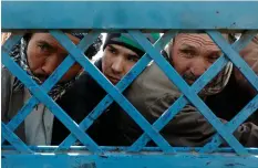  ?? (Reuters) ?? AFGHAN MEN line up to cast their votes during a parliament­ary election at a polling station in Kabul in October.