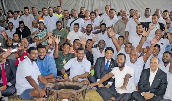  ?? Photo: Ronald Kumar. ?? Minister of Public Enterprise­s and Attorney-General Aiyaz Sayed-Khaiyum (middle), Fiji Ports Terminal Limited chairman Hasmukh Patel (front, row right) with workers following the bonus payout announceme­nt at the Kings Wharf in Suva on October 16, 2018.