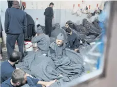  ?? REUTERS ?? Prisoners suspected of being part of the Islamic State lie inside a prison cell in Hasaka, Syria in January.