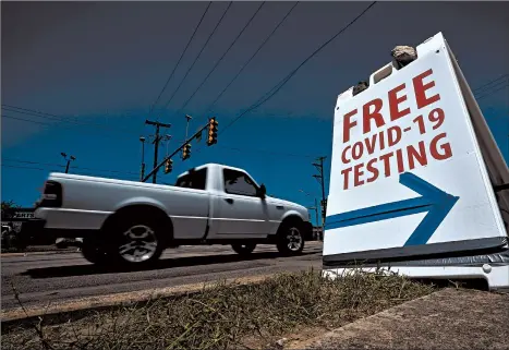  ?? ERIC GAY/AP ?? Coronaviru­s testing in Texas has dipped significan­tly, mirroring a nationwide trend. Above, a truck passes a sign for free COVID-19 testing Friday in San Antonio.