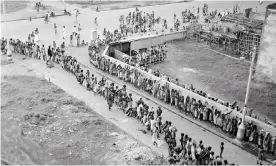  ??  ?? Indian citizens waiting in line at a soup kitchen. Photograph: Bettmann/Bettmann ArcThe