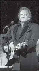  ?? Associated Press ?? ■ The 1997 file photo shows Johnny Cash performing at the Majestic Theatre in downtown Dallas.