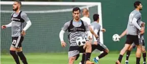  ??  ?? Iran’s Ehsan Haji Safi (centre) at a training session on Sunday.