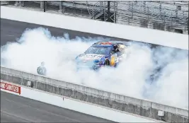  ?? Darron Cummings The Associated Press ?? Kevin Harvick performs a burnout Sunday after capturing the NASCAR Cup Series Big Machine Hand Sanitizer 400, or Brickyard 400, at Indianapol­is Motor Speedway.