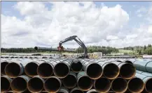  ?? Canadian Press file photo ?? Pipe for the Trans Mountain pipeline expansion is unloaded June 18, 2019, in Edson, Alta. The Supreme Court of Canada on Thursday dismissed an attempt by British Columbia to assert authority over what can flow through the expanded pipeline from Alberta.