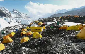  ?? — AFP ?? Ultimate prize or fate: Climbers (left) from Everest Base Camp (above) practising their techniques on the Khumbu glacier before trying to summit Everest, some 140km northeast of Kathmandu.