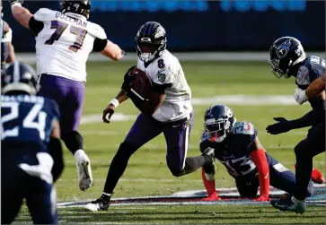  ?? AP PHOTO BY WADE PAYNE ?? Baltimore Ravens quarterbac­k Lamar Jackson (8) scrambles against the Tennessee Titans in the second half of an NFL wild-card playoff football game Sunday, Jan. 10, 2021, in Nashville, Tenn.