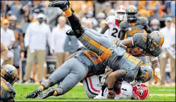  ?? BRANT SANDERLIN / BSANDERLIN@AJC.COM ?? Tennessee’s Derek Barnett (9), tackling Georgia running back Sony Michel last season, is part of a talented defensive line.