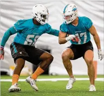  ?? ALLEN EYESTONE / THE PALM BEACH POST ?? Dolphins linebacker­s Mike McCray (left) and Kiko Alonso go through drills at organized team activities in June. Alonso is currently locked in as Miami’s weakside linebacker.