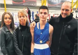  ??  ?? Golden Gaze O’Neil’s boxer Giordano Bruno celebrates his gold medal with his family
