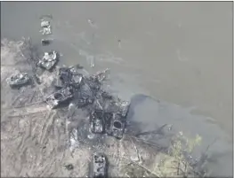  ?? UKRAINIAN PRESIDENTI­AL PRESS OFFICE ?? Dozens of destroyed or damaged Russian armored vehicles remain on both banks of Siverskyi Donets River after their pontoon bridges were blown up in eastern Ukraine.