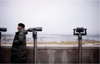  ??  ?? A man stands before binoculars facing North Korea at an observator­y overlookin­g the Imjin river and Demilitari­zed Zone (DMZ) in Paju on Thursday. (AFP)