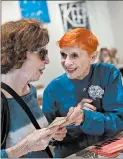  ?? BAIDI WANG/THE PHILADELPH­IA INQUIRER ?? Hostess Tina Caruso, 91, right, talks with a customer at Frieda, a cafe and gathering place in Philadelph­ia.