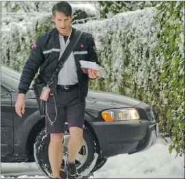  ??  ?? Letter carrier Ron Swirid doesn’t let snow stop him from delivering mail while wearing shorts. Canada Post says it has an on-time delivery rate of 96 to 98 per cent.