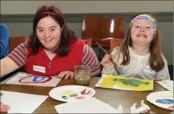  ?? LEFT: Photos by Michelle Cooper Galvin ?? FAR LEFT: Tara and Eoin participan­ts at the Summer Camp for teenagers with special needs with mentor Catherine Collins at the Old Community Hall, Milltown.
Angela and Caoimhe, enjoying the Summer Camp