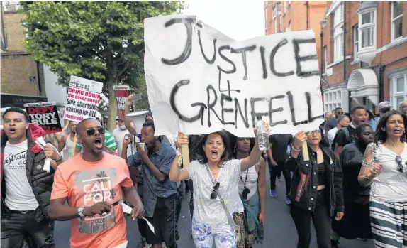  ?? AP ?? Scuffles broke out and demonstrat­ors chanted “we want justice” as they surged towards Kensington and Chelsea town hall offices.