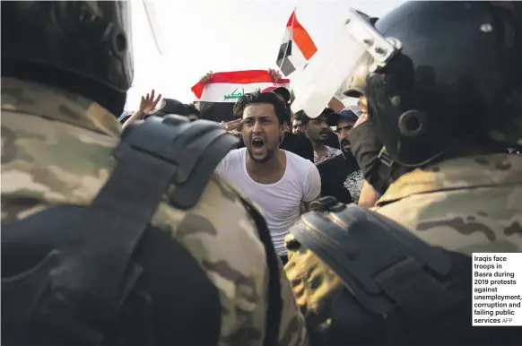  ?? AFP ?? Iraqis face troops in Basra during 2019 protests against unemployme­nt, corruption and failing public services