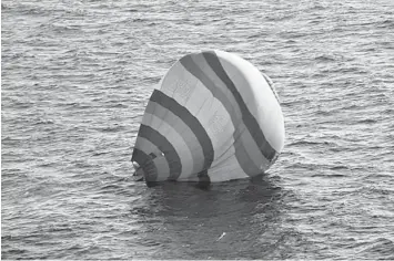  ?? AGENCE FRANCE PRESSE ?? A hot-air balloon carrying a Chinese man lands in the water near the disputed islands known as the Senkakus in Japan and Diaoyus in China, in the East China Sea.