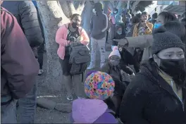  ?? GREGORY BULL — THE ASSOCIATED PRESS FILE ?? A woman seeking asylum in the United States waits with others in Tijuana, Mexico, for news of policy changes.