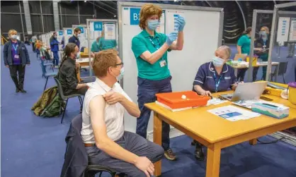  ?? Photograph: Paul Faith/AFP/Getty Images ?? ‘Crucially, we have vaccines that significan­tly reduce the severity of the disease.’ A temporary vaccinatio­n centre in Belfast.