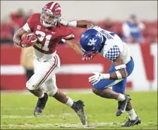  ?? AP- Mickey Welsh ?? Alabama running back Jase McClellan ( 21) tries to fend off Kentucky defensive back Kelvin Joseph ( 1) during an NCAA college football game in Tuscaloosa, Ala., on Saturday.
♦