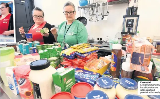  ??  ?? Essential
Kelly Drummond and Rose Marie Armour setting up food parcels for the needy