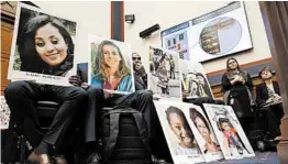  ?? JACQUELYN MARTIN/AP ?? People hold photos of those lost in Ethiopian Airlines and Lion Air crashes while they listen during a House Transporta­tion Committee hearing with Boeing executives.