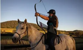  ?? Photograph: Aston Brown/The Guardian ?? Horse archery competitor Kimberley Robertson aiming her bow at her farm in Hirstglen, Queensland.