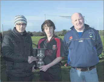  ??  ?? Shane Danials and Pat Dunne present the Ray Daniels Memorial Cup to Coolkenno captain Rory Tompkins in Dunlavin..