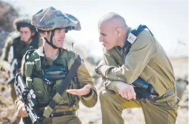  ?? (IDF Spokesman’s Office) ?? MAJ.-GEN. SAMI TURGEMAN (right) speaks with a soldier in the field.