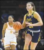  ?? Associated Press ?? Notre Dame forward Maddy Westbeld (21) dribbles upcourt as Tennessee guard Jewel Spear (0) pursues during an NCAA basketball game on Wednesday in Knoxville, Tenn.